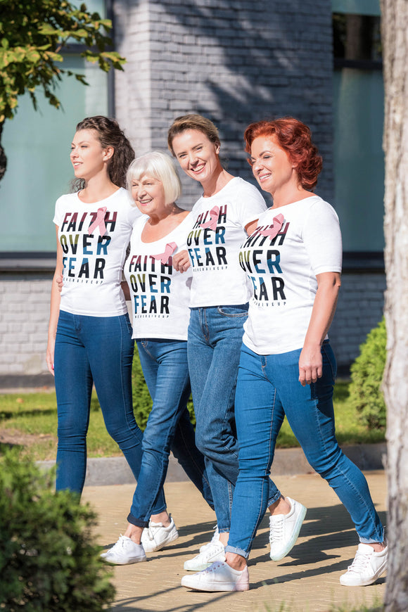 Four women walking for Cancer wearing matching T-shirts with the words Faith Over Fear. 